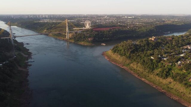 International Bridge of Integration over Uruguay River connecting Sao Borja in Brazil and Santo Tom&eacute; in Argentina. Aerial forward at sunset 