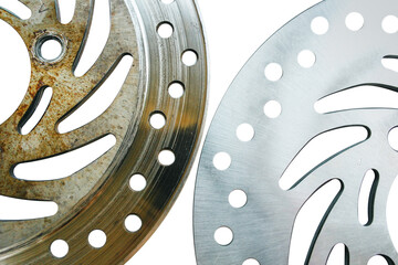 Comparison of new and old motorcycle disc brakes Metal disc brakes have holes for cooling. close-up...