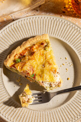 Piece of freshly baked quiche with salmon and broccoli