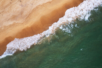 Plakat Aerial view of sea crashing waves White foaming waves on beach sand, Top view beach seascape view Nature background