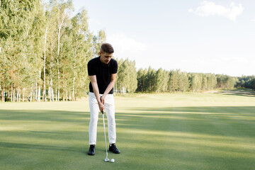 A man golfer plays on the field. Time for golf. High quality photo