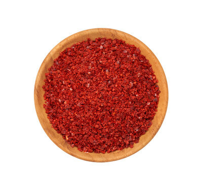 a pile of red pepper flake or heap of red pepper powder coarse. korean chili ground Gochugaru in wood bowl isolated on white background. top view, flat lay, overhead                           