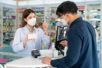 Asian pharmacist woman with protection mask in pharmacy store
