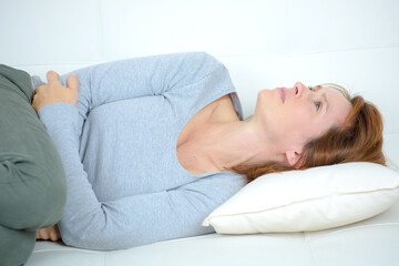 woman curled up on sofa