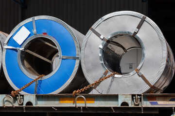 Roll of rolled steel sheet on transport truck. metal coils with fastener on truck ready for...