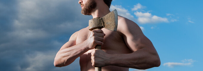cropped view of shirtless man with axe. caucasian man hold ax. brutal man on sky background