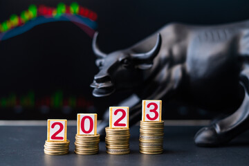 Concept showing of 2023 bullish stock market by placing coins in increasing order with running...