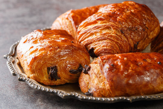 Homemade Chocolate Croissants Pain au Chocolat closeup in the plate on the table. Horizontal