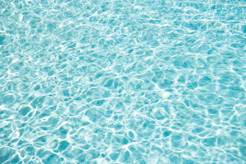 summer paradise. blue swimming pool water background with ripples