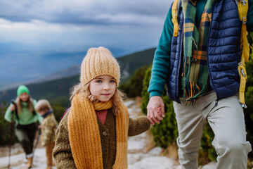 Happy family hiking together in autumn mountains.