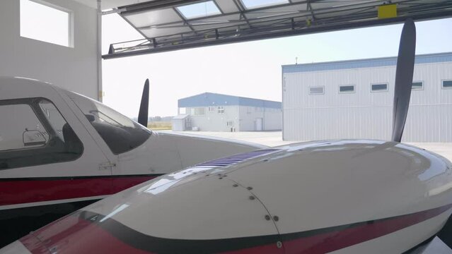 Aircraft in Hangar with Closing Door, Close Up Engine Cowling and Prop