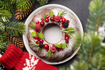 Christmas cake with pomegranate seeds, cranberries and rosemary