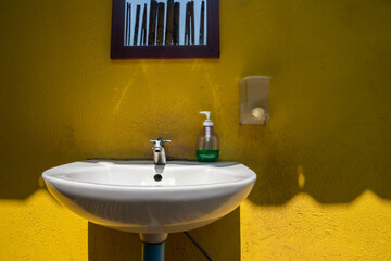 single sink vanity and skylights in bathroom in yellow tones