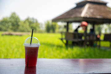Watermelon juice on  wood table on blurred nature background