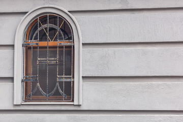 forged steel grating on an arched window.