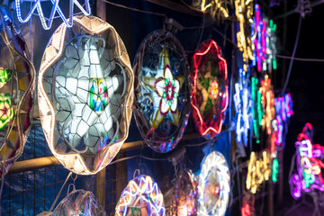 Parols for sale at a stand at nighttime. A Filipino ornamental lantern displayed during the...