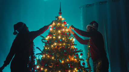 Couple are making the Christmas tree decoration in the night