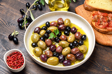 Mixed green olives and black olives with olive oil, healthy eating antioxidants