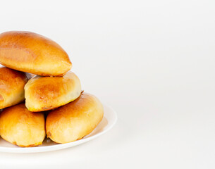 Pies on a white plate on a white background.