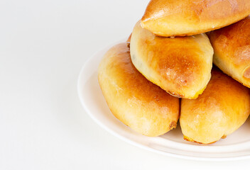 Pies on a white plate on a white background.