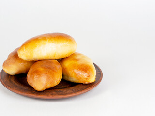 Pies on a dark plate on a white background.