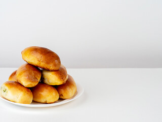 Pies on a plate on a light background with room for text .Homemade food concept.