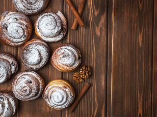 Fototapeta premium Cinnamon and walnut yeast-free buns on a wooden background. A healthy eating concept.