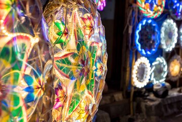 A stall by the street selling various lighted Christmas Parols. Parols are a traditional Filipino...
