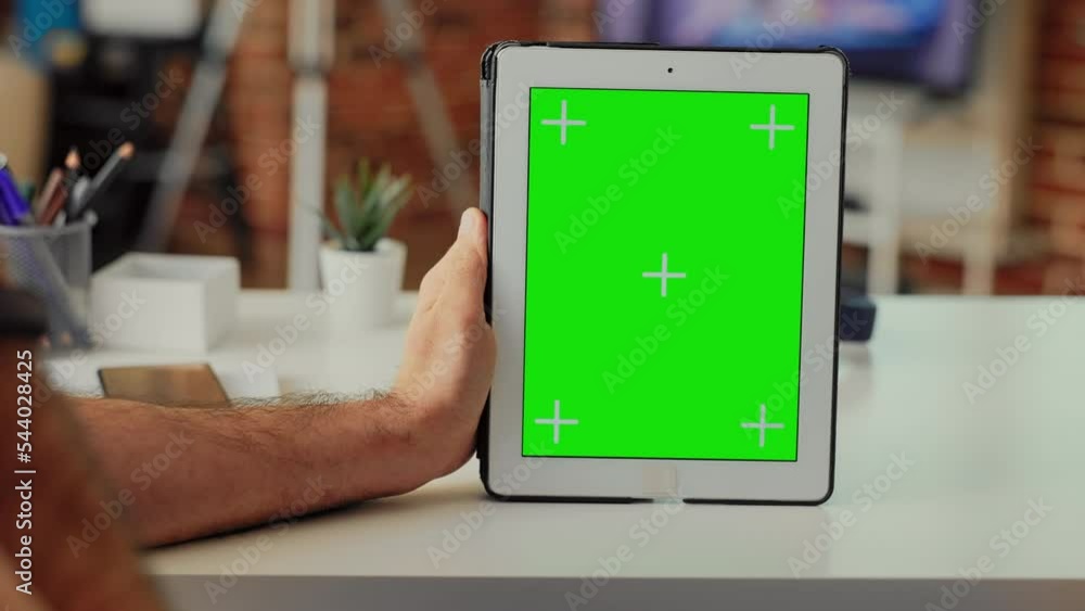 Aufkleber office employee holding digital gadget showing greenscreen template, analyzing isolated mockup displ