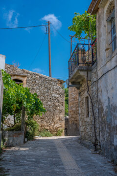 Empty alley with buildings under blue sky
