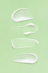 cosmetic smears cream texture on pastel green background
