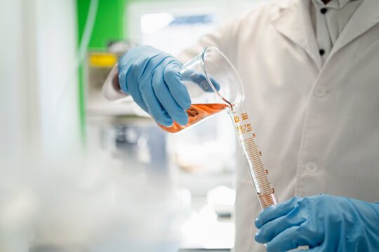 Scientist with test tube doing thermolysis experiment in laboratory