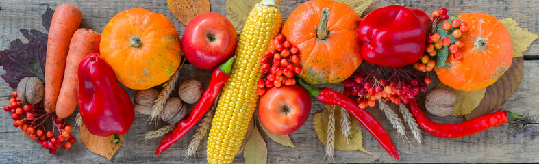 Autumn background set, fallen leaves, fruits, vegetables, wooden table.