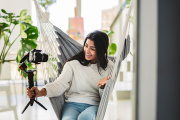 Hindu woman recording a video with a professional camera for social networks. Millennial indian...