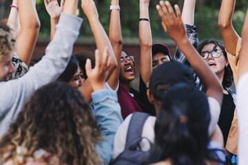 Happy young people cheering at a school event