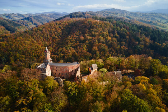 Aerial top view of Grodno castle in Zagorze with beautiful autumn landscape. Old historical fortress in mountains, covered with forest. Poland landmarks for tourists