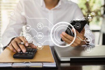 Investors working using calculator to calculate with smartphone, laptop the tax of static in office. Finance accounting concept.