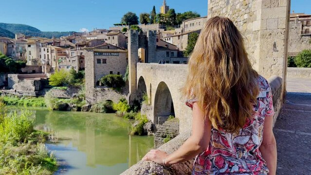 Woman tourist on the bridge of Besalu- catalonia in Spain