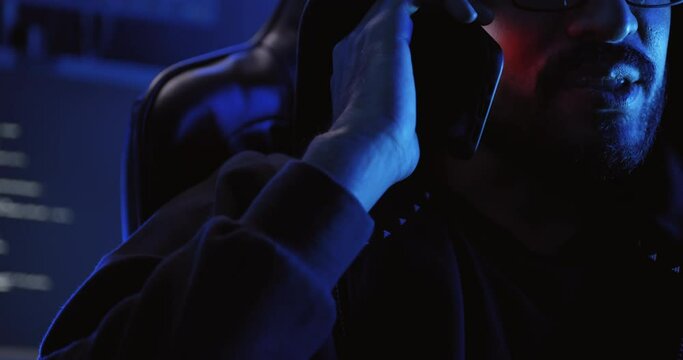 A male hacker is using a computer to hack data to demand ransom from victims.