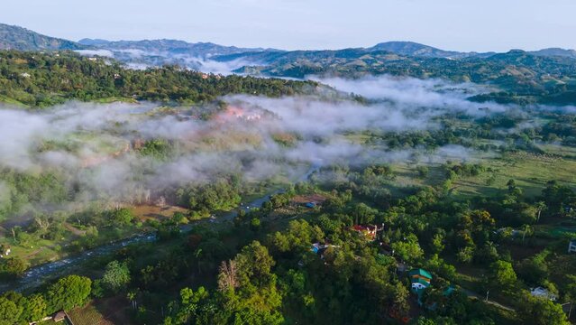 Stunning aerial view of the mountains with dense fog and a river, winter weather in the caribbean