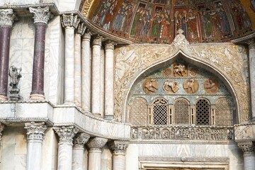 Beautiful St Mark's basilica wall facade with marble columns background, luxury gold ornate painting, and decorative detail. 