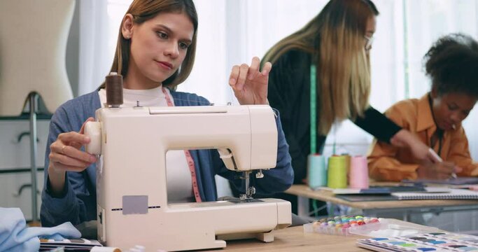 A group of young women are learning the profession of design and tailoring.