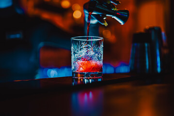 woman bartender hand making cocktail in nightclub