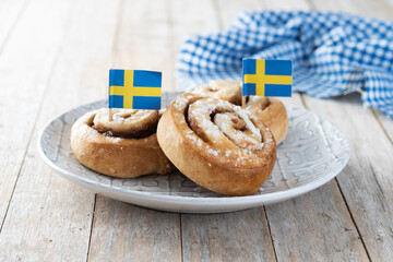 Cinnamon rolls buns on wooden table. Kanelbulle Swedish dessert