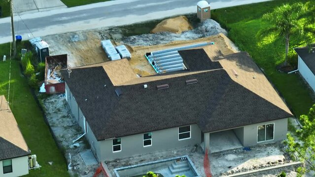 Aerial view of residential private home under construction and yard ground works with septic drain field installation in Florida quiet rural area. Real estate development concept
