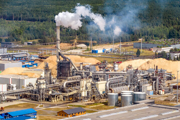 aerial panoramic view on smoke of pipes of chemical or wooden enterprise plant. Industrial...