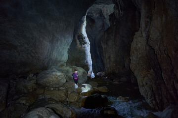 Woman hiking into a cave