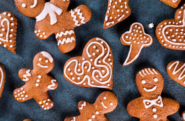 Homemade gingerbread cookies on dark background. Christmas composition, new year background. Christmas dessert. New Year flatlay.