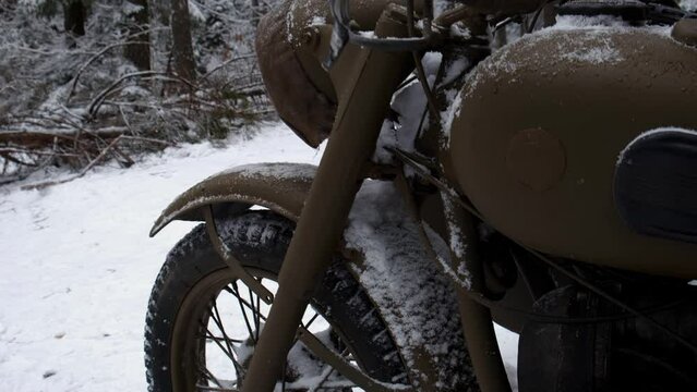 an old Soviet motorcycle with a sidecar in the winter forest