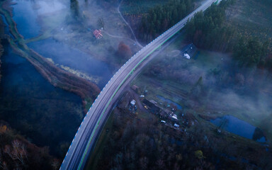 The landscape from the flight of the drone on the river valley is obscured by fog